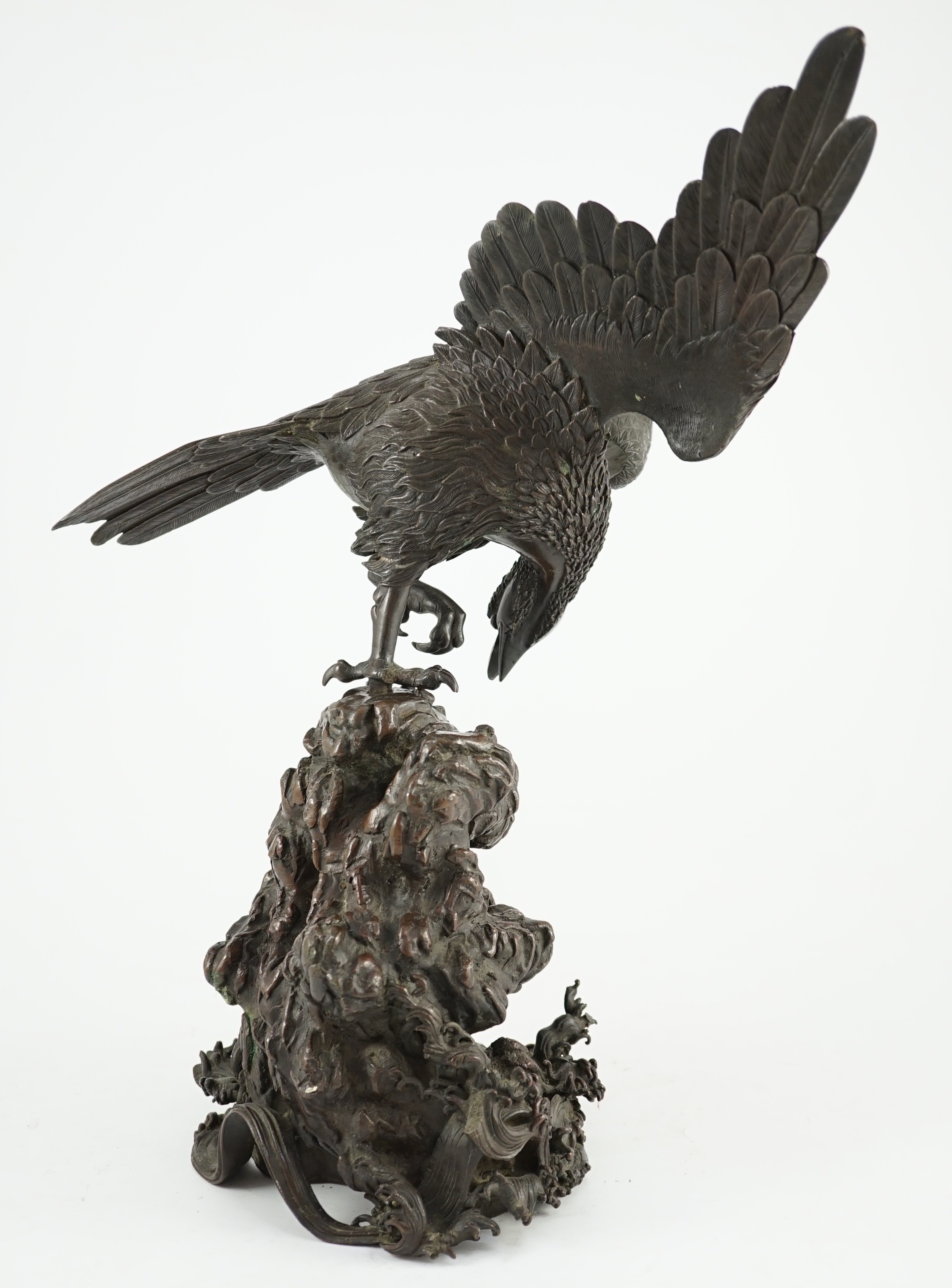 A Japanese bronze model an eagle standing on a rock, Meiji period, 44.5cm high